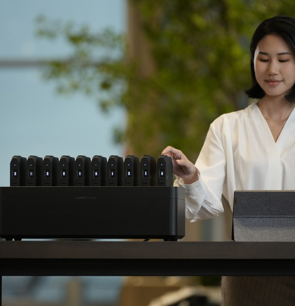 Staff member taking a power bank from a Power Station