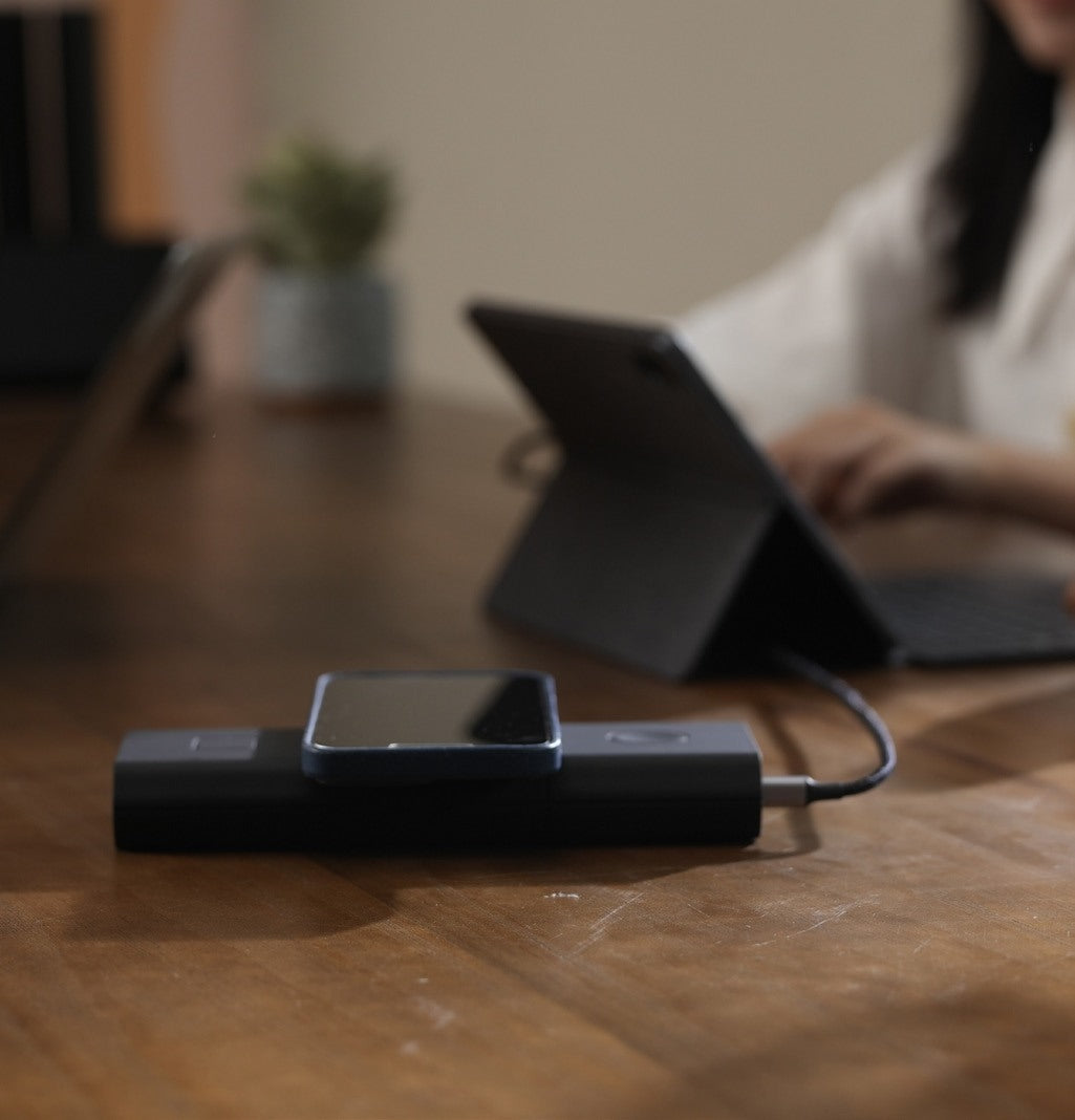 Omni power bank charging a tablet on a desk