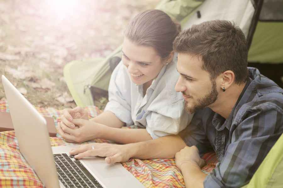 A couple using a battery camping in a tent