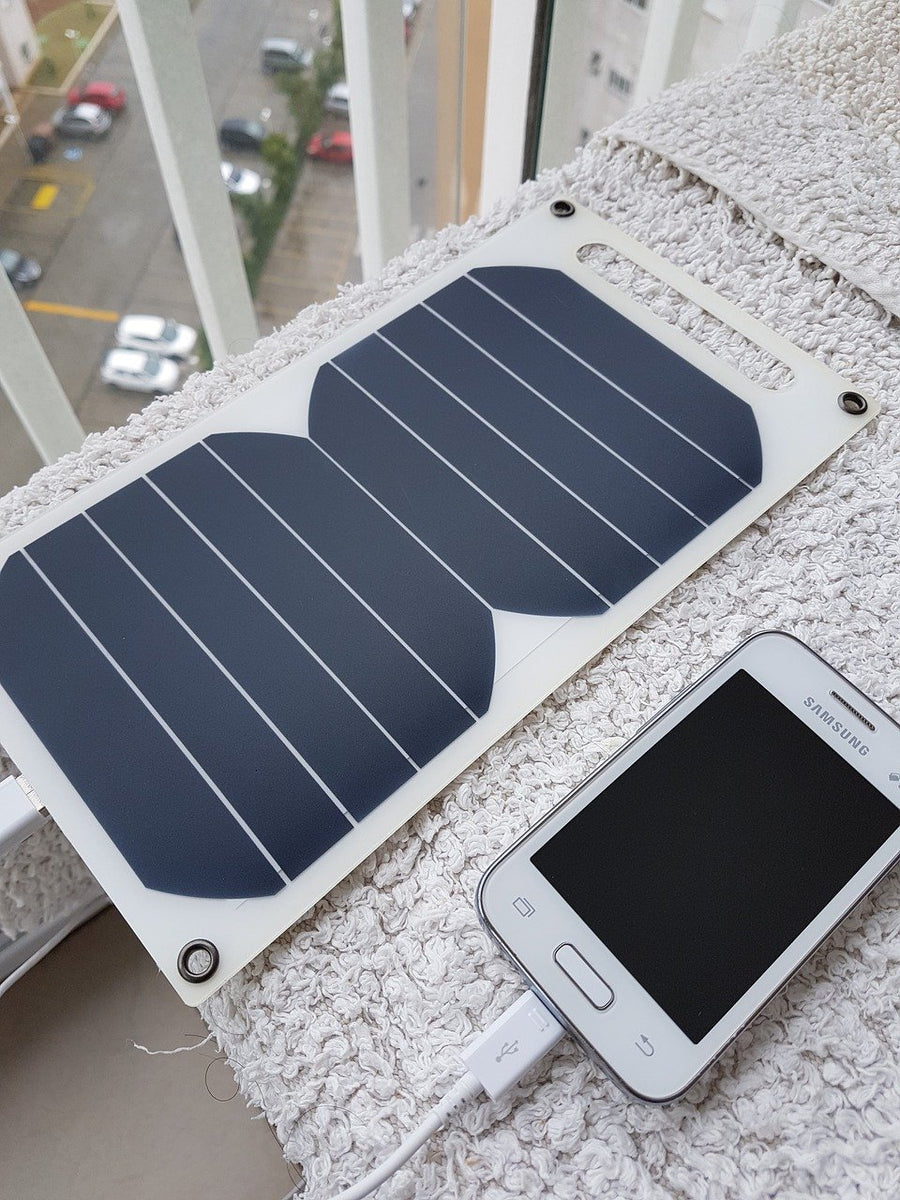 A portable solar panel hooked up to a phone