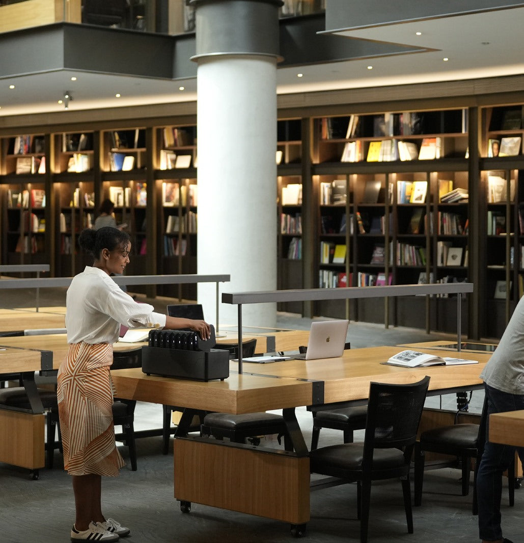 Staff lending power banks from a Power Station in a library