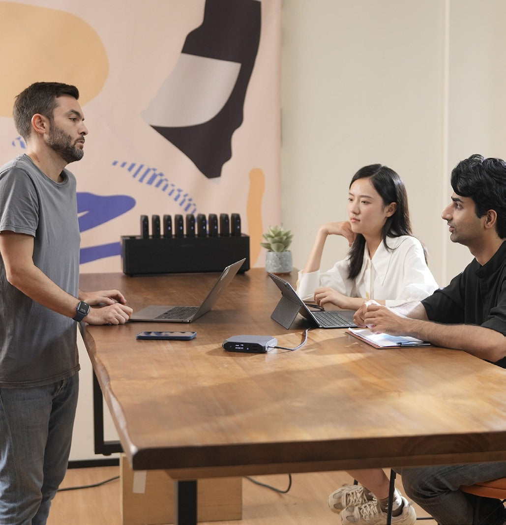 Students at a table with a Power Station and laptops
