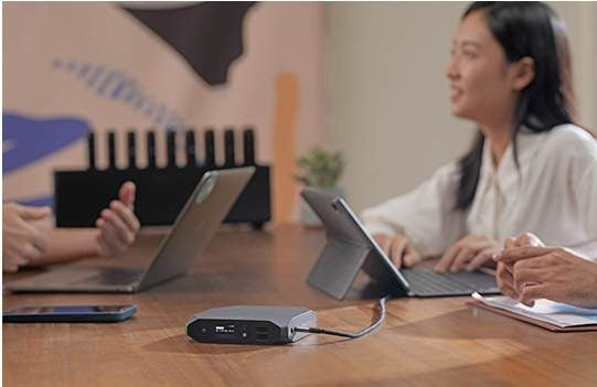 Attendees using Omnicharge power banks at a meeting