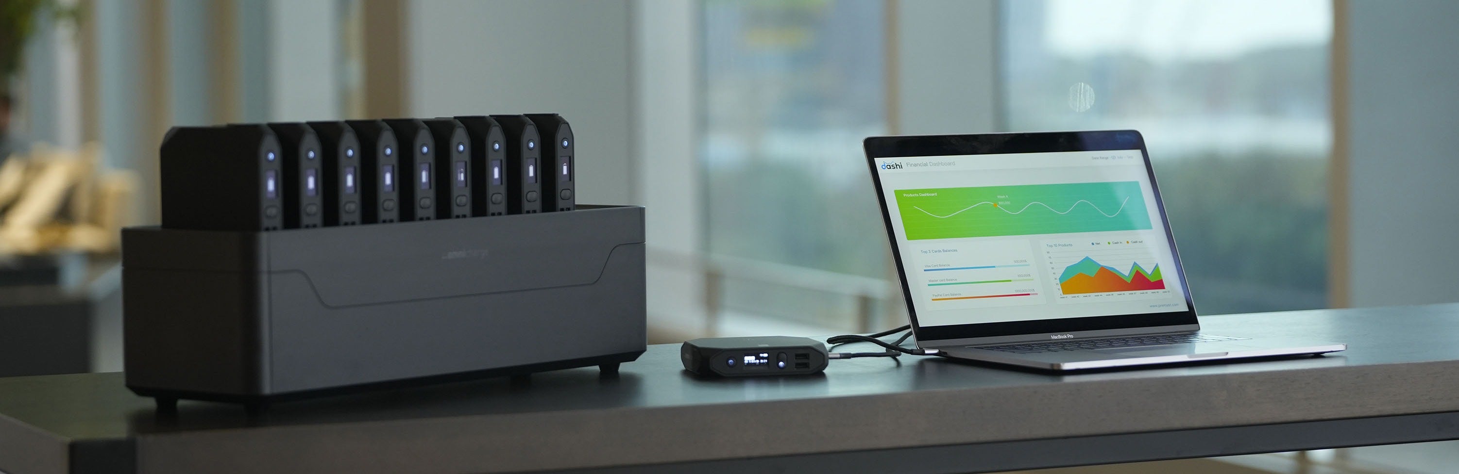 Omni Power Station next to a laptop on a desk