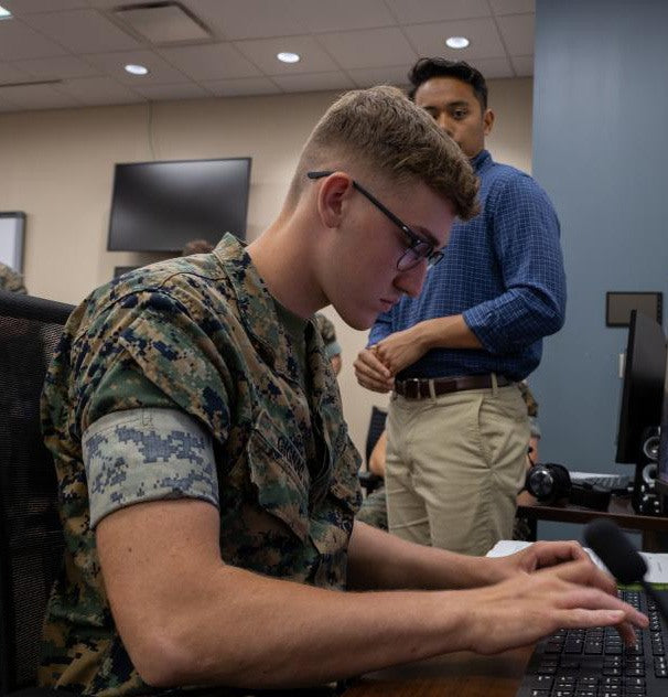 Service member working on a laptop