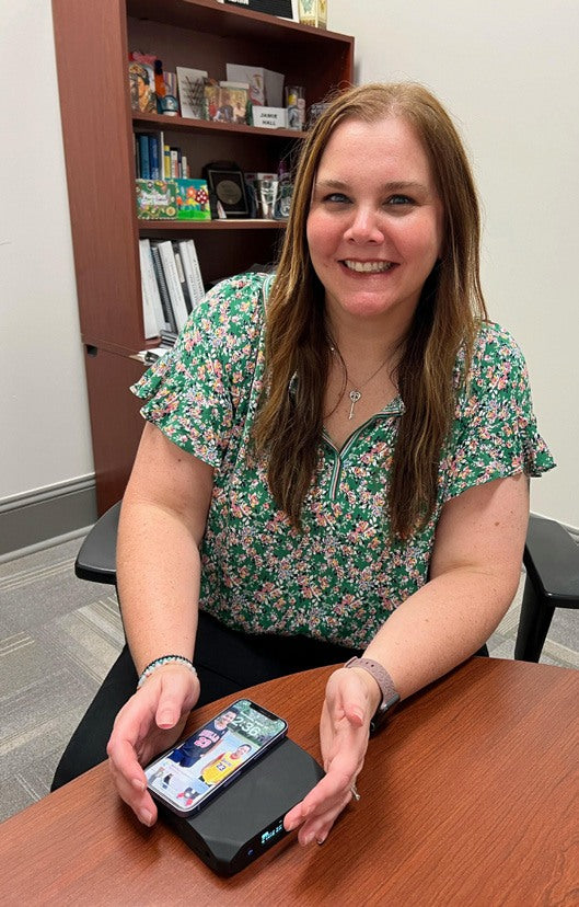 NSU staff member holding an Omnicharge power bank