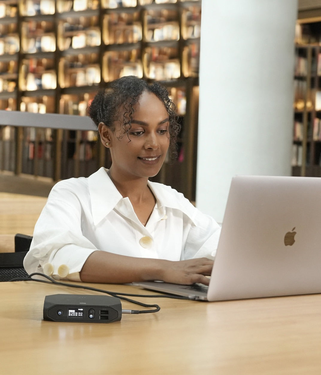 Student using a laptop powered by an Omnicharge power bank