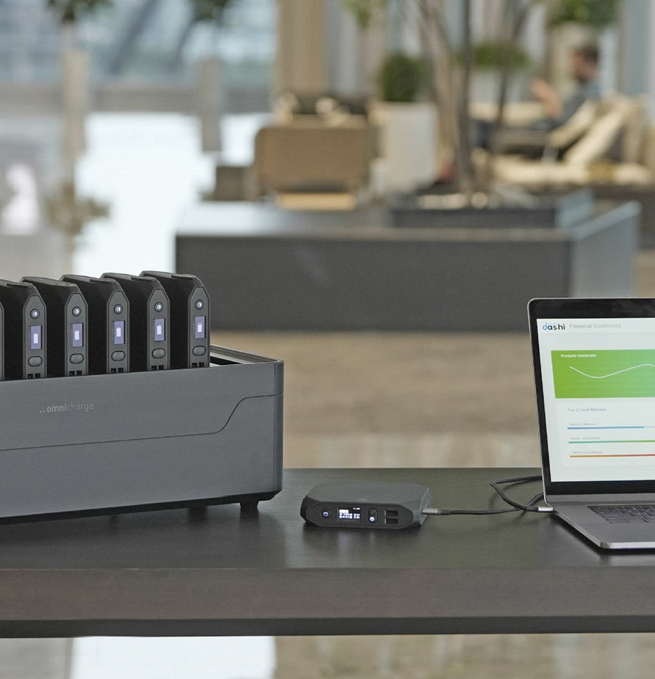 Omnicharge Power Station next to a laptop in a library
