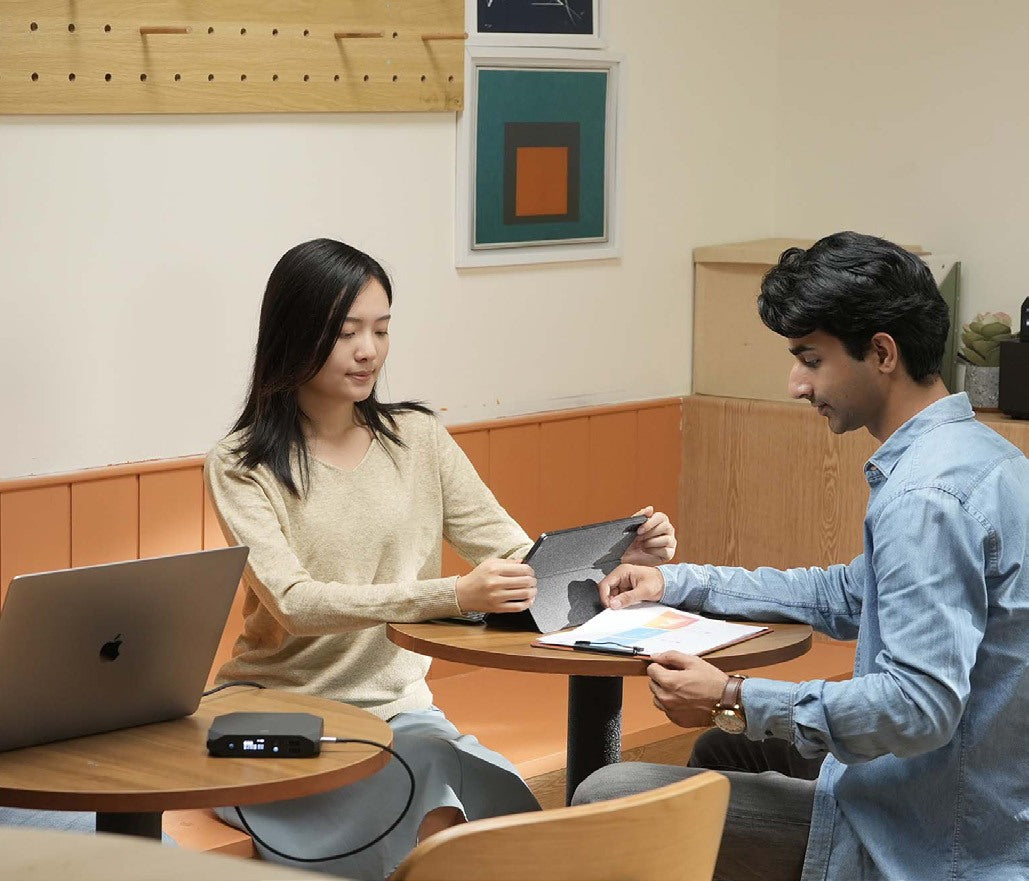 Students working at a table with a power bank
